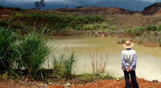 Villager looks at a company jade mining site in Lone Khin town