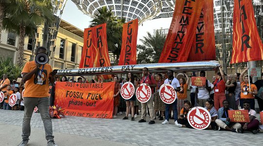 Fossil fuel phase-out protest outside of the Brazil pavilion at COP28.jpg