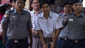 Detained Myanmar journalists Kyaw Soe Oo (front) and Wa Lone (back) are escorted by police to a courtroom for on going trial in Yangon on August 20, 2018.