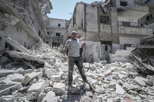Man in debris - Idlib, Syria