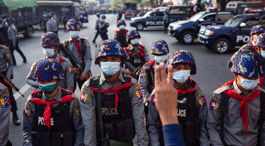 Riot police stand on guard in front of the Central Bank building during a demonstration in Myanmar, February 2021