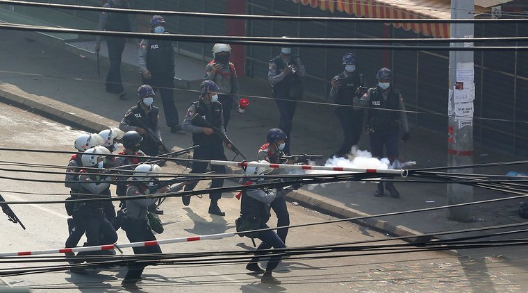 Riot police fire tear gas at protesters during a violent crackdown on demonstrations against the military coup in Yangon Myanmar, February 2021
