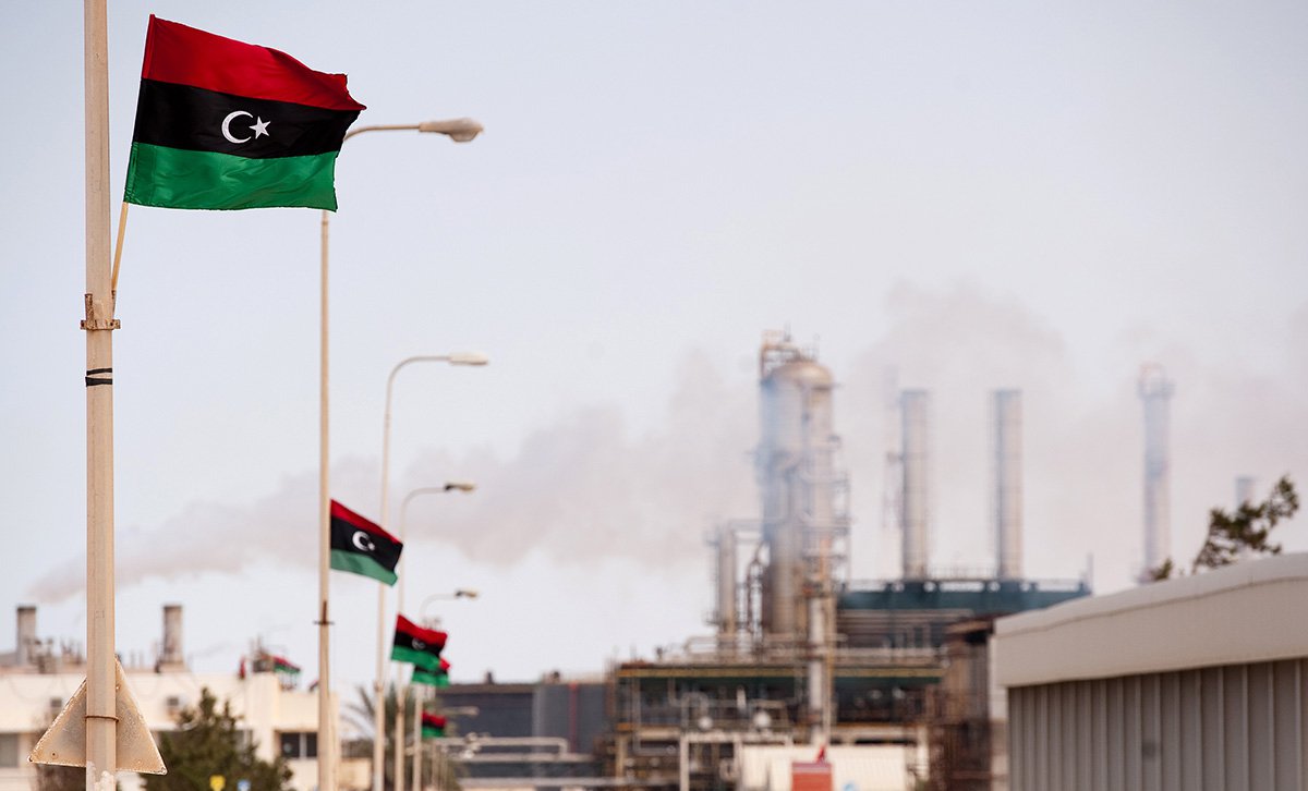 Libyan flag flutters outside an oil refinery in Zawiya on September 23, 2011