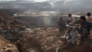Freelance Yemase miners sit on the top of a hill in Hpakant, Myanmar