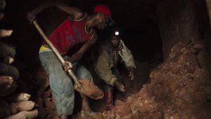 Artisanal miners dig a tunnel of a cassiterite mine