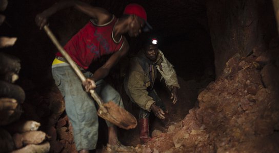 Artisanal miners dig a tunnel of a cassiterite mine