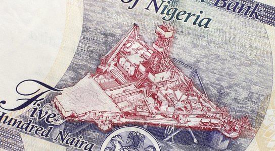 Part of Nigerian currency with oil platform