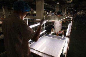 Workers assemble solar panel in China.jpg