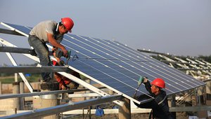 Workers install solar panels in China.jpg