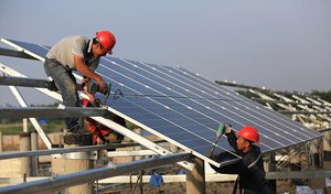 Workers install solar panels in China.jpg